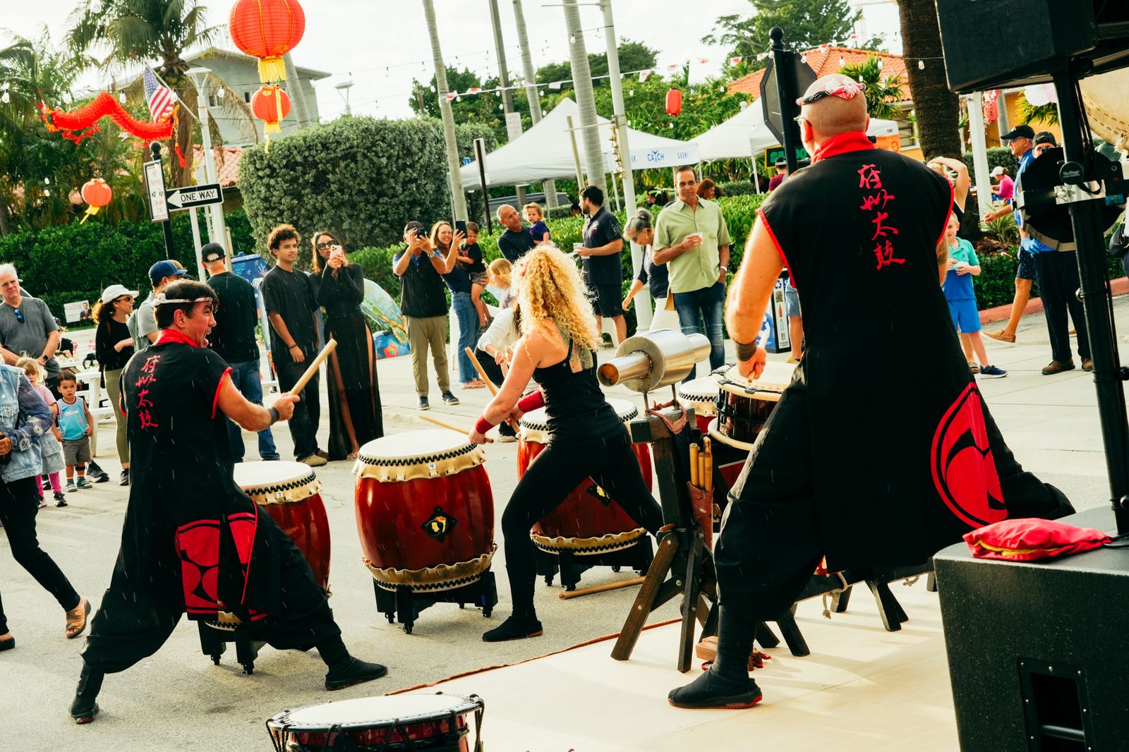Taiko drummers performing on the street at dusk
